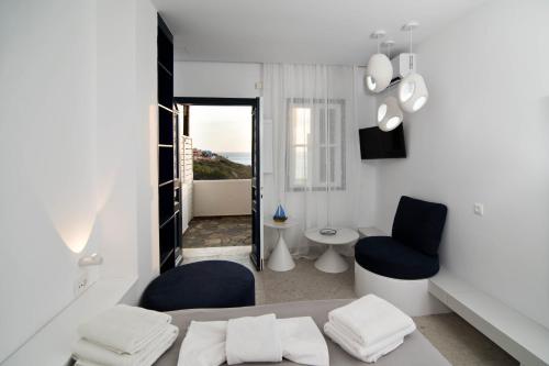 a white room with two chairs and a toilet at Blue Dawn Kalymnos in Kalymnos