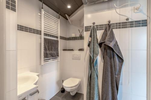 a bathroom with a shower and a toilet and a sink at B&B de oude melkfabriek in Valkenswaard