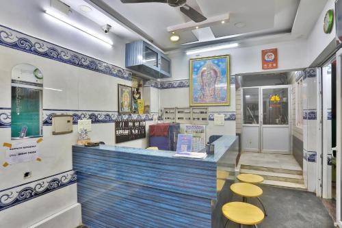 a restaurant with a blue counter with two stools at SAMPATH RESIDENCY in Palni