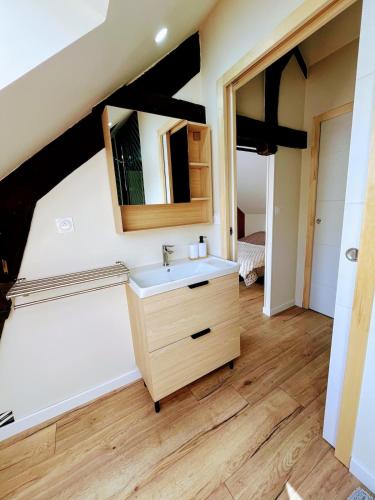 a bathroom with a sink and a mirror at Maison de vacances proche de Pontmain in Saint-Mars-sur-la-Futaie