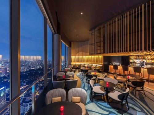 a restaurant with tables and chairs and a view of a city at Swissotel The Stamford Singapore in Singapore