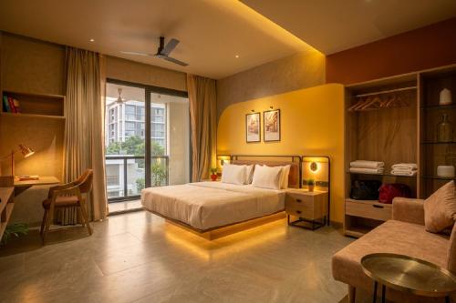 a bedroom with a bed and a desk and a couch at Arpan Retreat in Jaipur