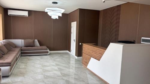 a living room with a couch and a tv at Meridian Hotel in Georgīevka