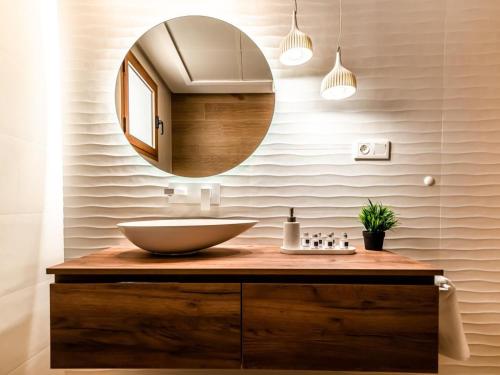 a bathroom with a sink and a mirror at Renteando Albir Apartments in Albir