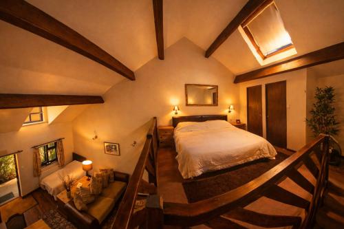 a bedroom with a large bed and a staircase at Langford Apartment and Rooms in Bristol
