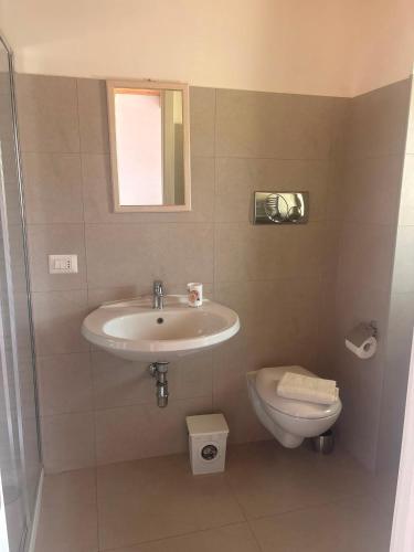 a bathroom with a sink and a toilet at L'Incanto del mare GC in Saline Joniche