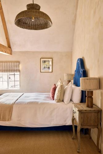 a bedroom with a bed with pillows on it at The Wheatsheaf in Chilton Foliat