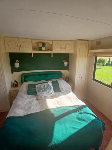a bedroom with a large bed in an rv at DanowskieCamp in Danowskie