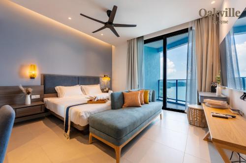 a bedroom with a bed and a couch at Assana Cenang Beachview oakville by sync in Pantai Cenang