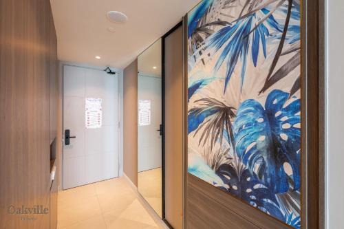 a hallway with a large painting on the wall at Assana Cenang Beachview oakville by sync in Pantai Cenang