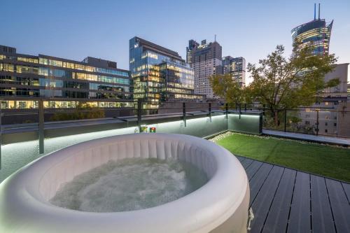 a bath tub on the roof of a building at Unique Tower Business View Apartment in Warsaw