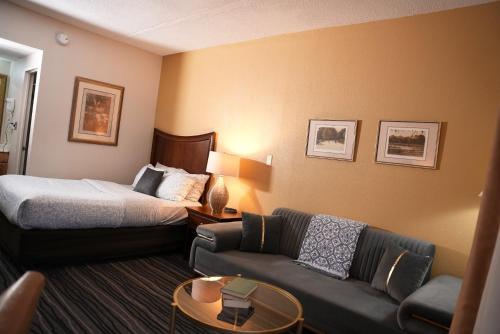 a hotel room with a bed and a couch at Kiteville Owego in Owego