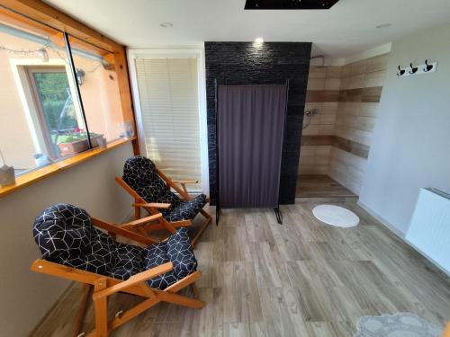 a room with two chairs and a door at Chata Monika Veľké Pole in Veľké Pole