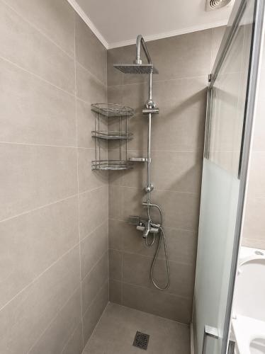 a bathroom with a shower with a shower head at Clio's house in Áyioi Dhéka