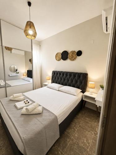 a bedroom with a large bed with towels on it at Clio's house in Áyioi Dhéka