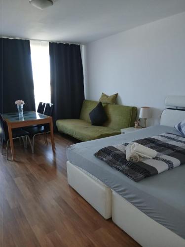 a bedroom with a bed and a couch and a table at B1011, gemütliches Appartement mit Ausblick in Lahnstein