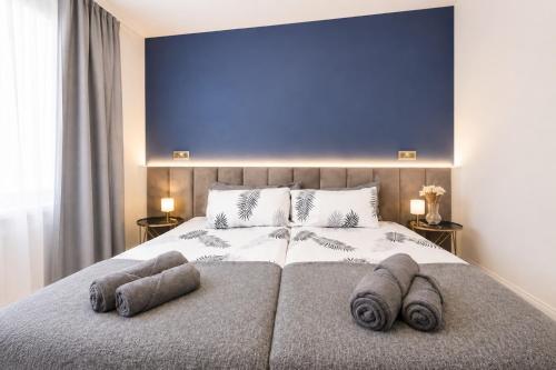 a bedroom with a large bed with towels on it at Stylish 2BR House Parking & WiFi Sleeps 6 in Grangemouth