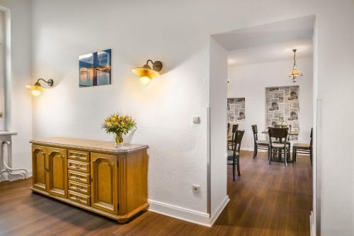 a dining room and living room with a table at Signature Hotel Astoria in Hamburg