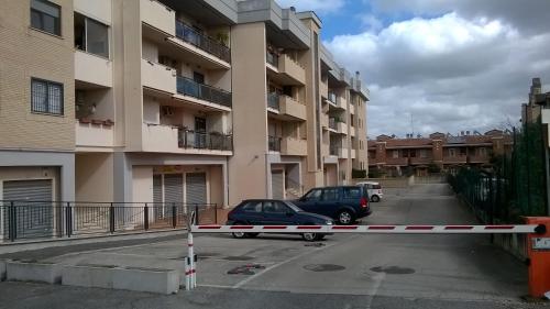 a parking lot with two cars parked in front of a building at A casa con Stefania in Settecamini