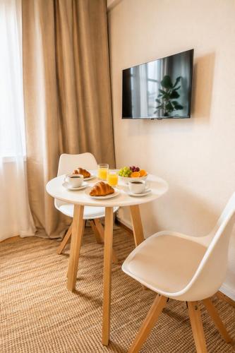 a white table with food on it in a room at Alppila Lodge Studio in Helsinki
