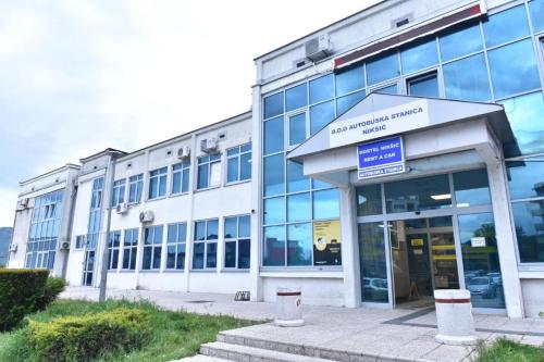 an office building with a sign in front of it at Hostel Nikšić in Nikšić