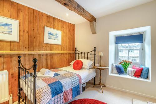 a bedroom with a bed and a window at 3 Bed in Askrigg oc-ds779 in Askrigg