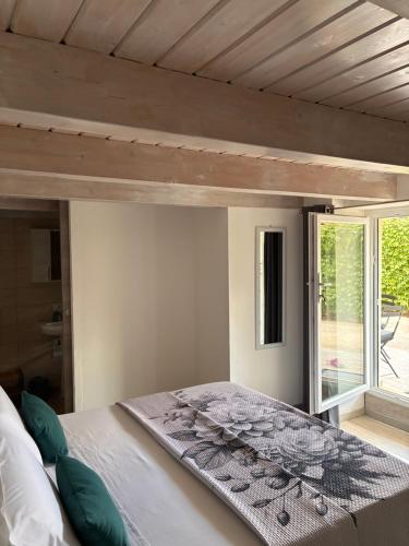 a bedroom with a large bed with a window at B & B Sotto al lago in Nemoli