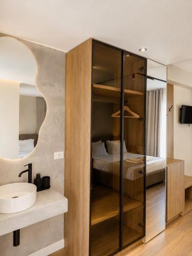 a bedroom with a bed and a glass closet at Zador Hotel in Ksamil