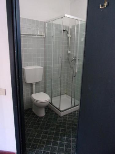 a bathroom with a toilet and a glass shower at Hotel Fiascherino in Lerici