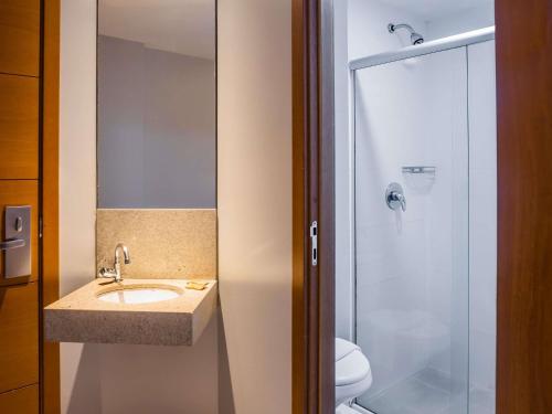 a bathroom with a sink and a shower at ibis Styles Belém do Pará in Belém