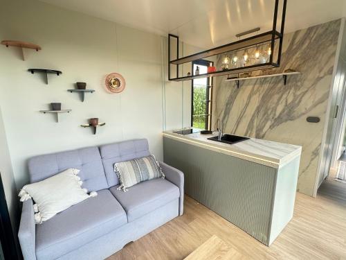 a living room with a couch and a counter at Domki Machnice in Machnice