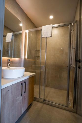 a bathroom with a glass shower and a sink at Letstay Marine Homes in Antalya