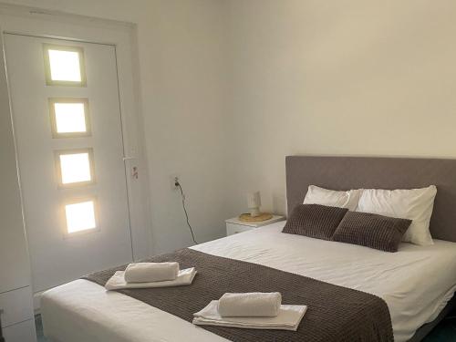 a bedroom with a bed with two towels on it at VERIGE VIEW Kamenari in Donja Jošica