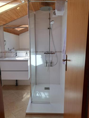 a glass shower in a bathroom with a sink at Casa Vida Alegre in Prazeres