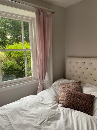 a bed in a bedroom with a window at Collingwood House Tynemouth in Tynemouth