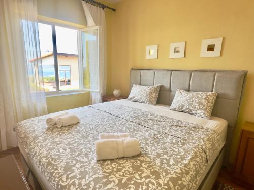 a bedroom with a bed with two towels on it at Holiday Home Nives in Tivat