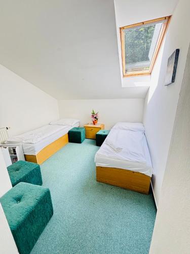 a small room with two beds and a window at Hotel Salaš in Šenov u Nového Jičína