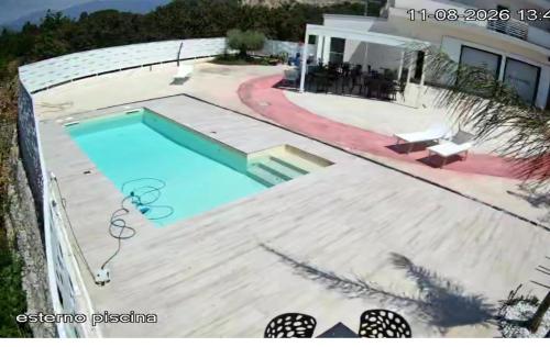 a swimming pool in front of a house at Hotel Doc in Vairano Scalo