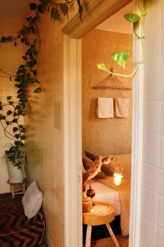 a bedroom with a bed and a table in a room at The FlowHost in Tamraght Ouzdar