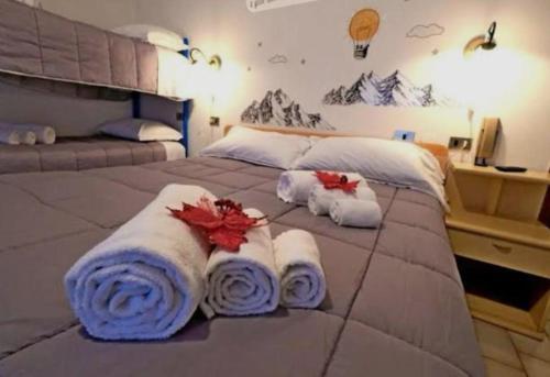a bedroom with a large bed with towels on it at Locanda San Nicolo - Sestola Centro in Sestola