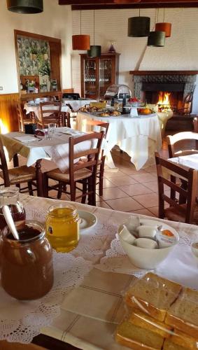 a dining room with tables and chairs and a fireplace at Locanda San Nicolo - Sestola Centro in Sestola