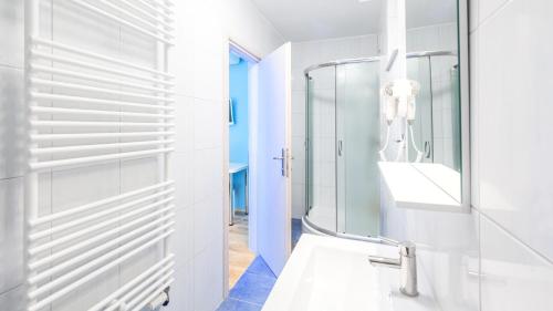 a bathroom with a glass shower and a sink at Zlatni Lug in Požega