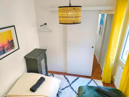 a living room with a chair and a lamp at Maison de la Liberté - Petite maison à 4 étages in Nyons