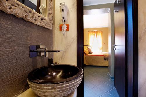 a bathroom with a large bowl sink and a bedroom at B&B Il Parco in Monterosso al Mare