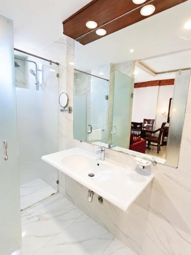 a bathroom with a sink and a mirror at Viridi Hotels Islamabad in Islamabad