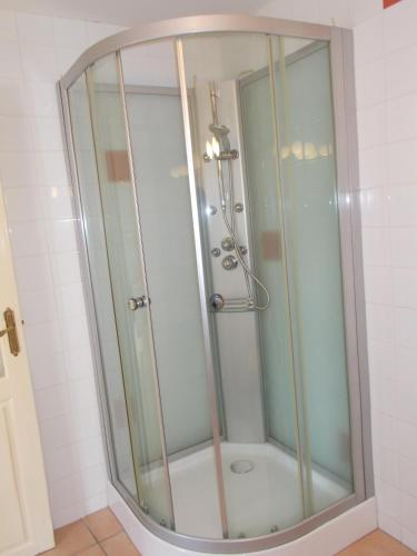 a shower with a glass door in a bathroom at Poppys Chambres d'Hotes in Céret
