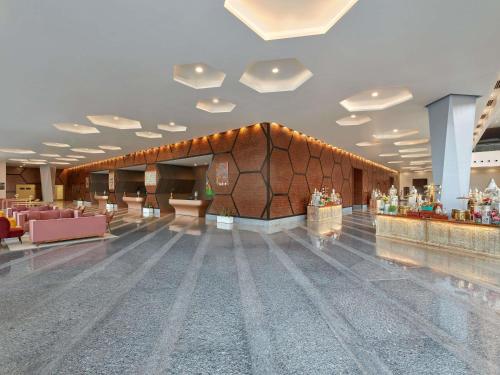 a large lobby with a bar in a building at Novotel Jaipur Convention Centre in Jaipur
