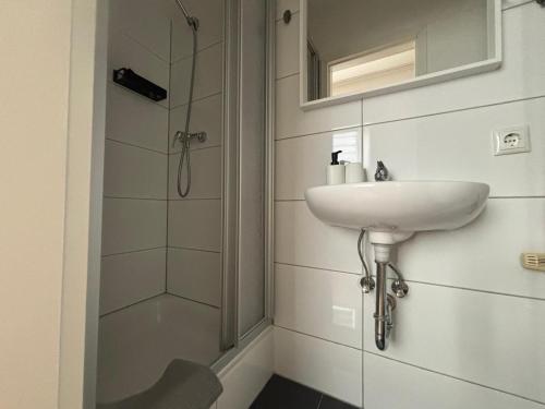 a bathroom with a sink and a shower at Zimmer für 2 Personen-Bad-Kühlschrank-TV-11 in Meine