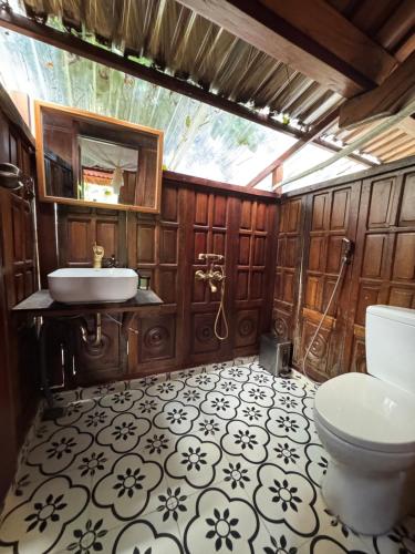 a bathroom with a toilet and a sink at Núi Dinh Stilt House - Phú Mỹ in Ấp Long Cát