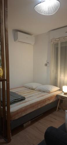 a bedroom with a large bed with a light at À la brise marine in Saint-Benoît
